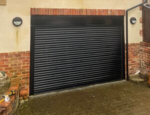 Roller shutter repairs Bolton - engineer repairing a domestic roller shutter door